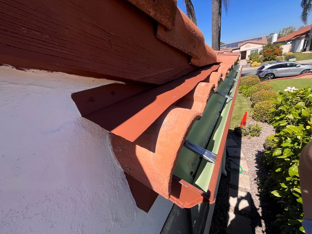 Approved AWC work photograph of a metal gutter at a roof edge